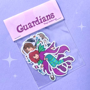 May include: A clear plastic bag containing a set of vinyl stickers. The stickers feature cartoon illustrations of characters with various hair colors and outfits. The bag has a light purple header with the word "Guardians" and "Vinyl sticker set".
