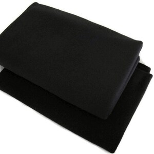 May include: Two black fabric squares folded on top of each other.