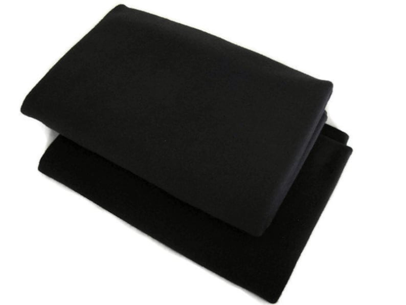 May include: Two black fabric squares folded on top of each other.