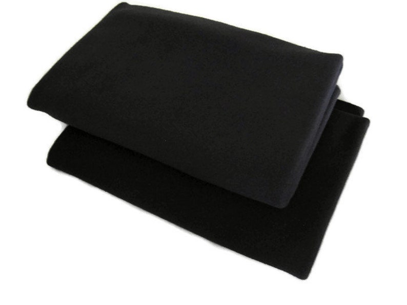 May include: Two black fleece blankets folded on top of each other.