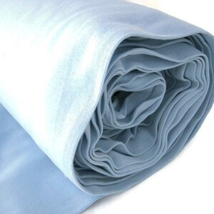 May include: A roll of light blue fabric. The fabric is soft and smooth, and it is perfect for sewing projects.