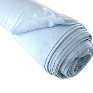 May include: A roll of light blue fabric. The fabric is soft and smooth, and it is perfect for sewing projects.