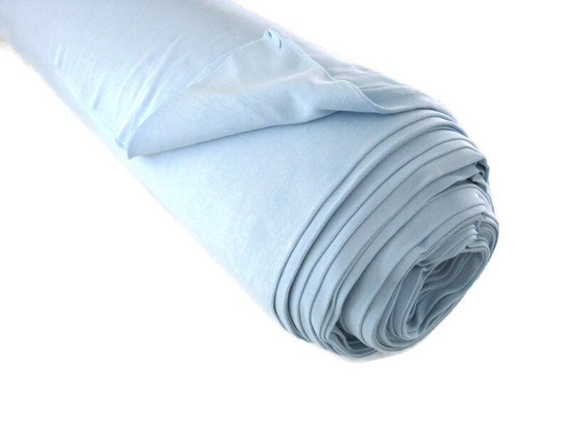 May include: A roll of light blue fabric. The fabric is soft and smooth, and it is perfect for sewing projects.