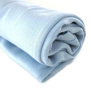 May include: A light blue rolled up fabric, possibly a blanket or towel.