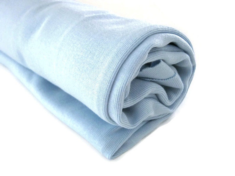 May include: A light blue rolled up fabric, possibly a blanket or towel.