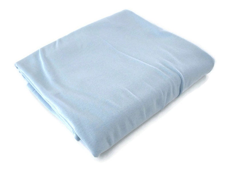 May include: A light blue fitted sheet, folded and displayed on a white background.