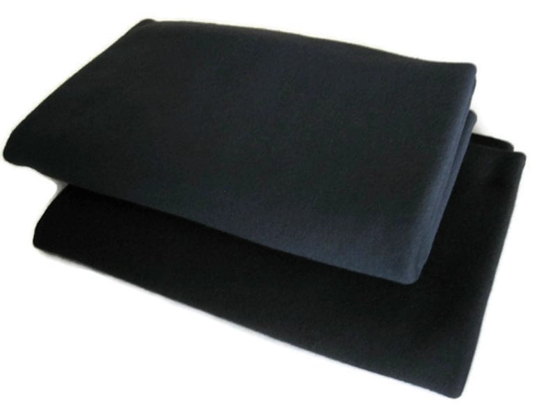 May include: Two black fleece blankets folded on top of each other.