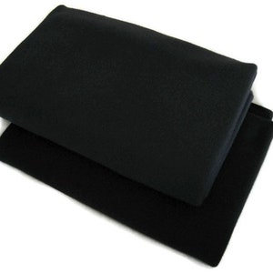 May include: Two black fabric squares folded on top of each other.