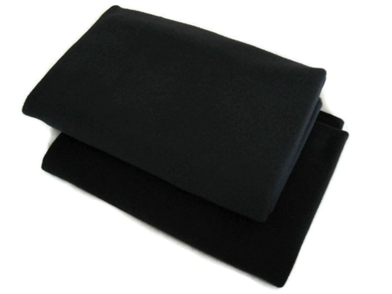 May include: Two black fabric squares folded on top of each other.