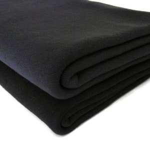 May include: A black fleece blanket folded in thirds. The blanket is soft and plush, and it is perfect for keeping warm on a cold day.
