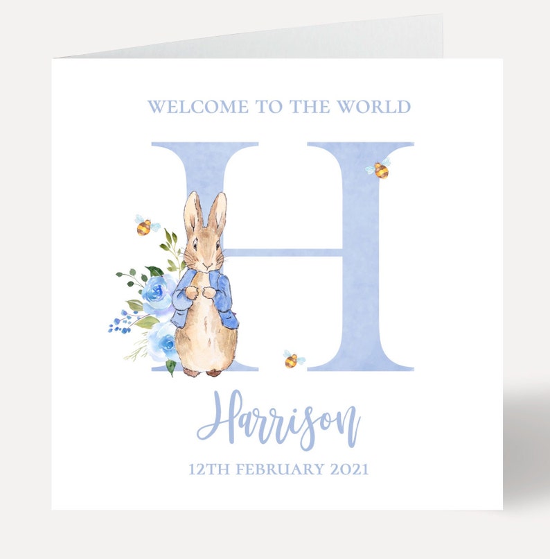 May include: A blue and white baby shower card with a watercolor illustration of Peter Rabbit and the letter H. The card says "Welcome to the world Harrison 12th February 2021".