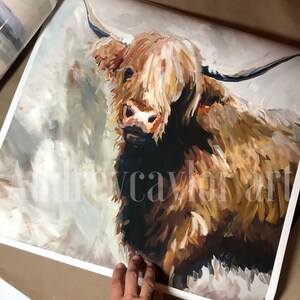 May include: A painting of a Highland cow with long, shaggy brown and white fur. The cow is looking directly at the viewer with a gentle expression. The background is a soft, muted gray.