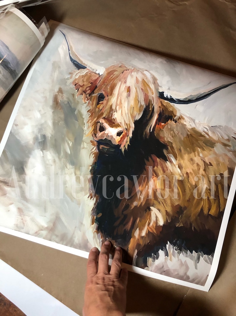 May include: A painting of a Highland cow with long, shaggy brown and white fur. The cow is looking directly at the viewer with a gentle expression. The background is a soft, muted gray.
