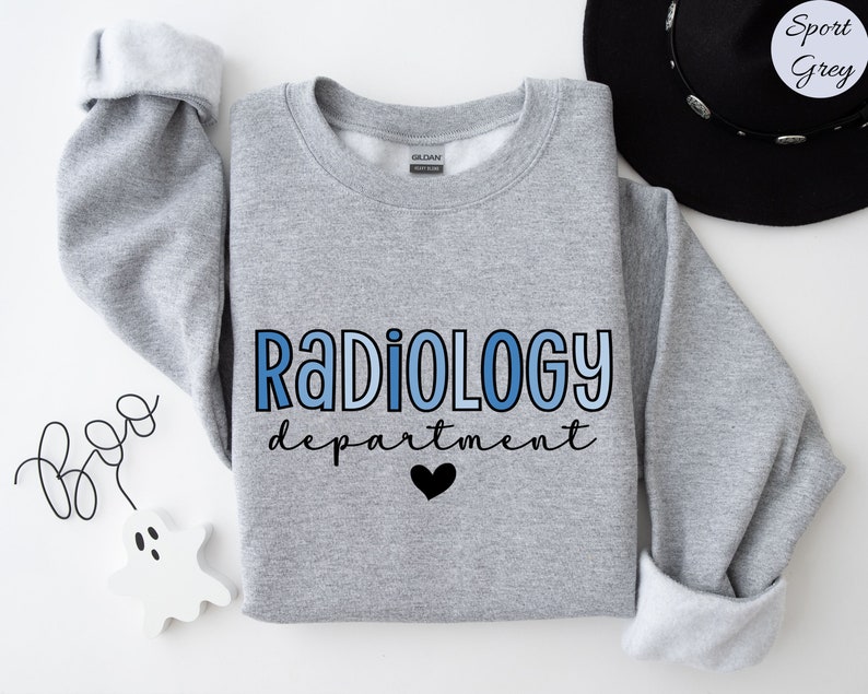 May include: A gray sweatshirt with the text "Radiology department" in blue and black lettering. A small black heart is below the text.