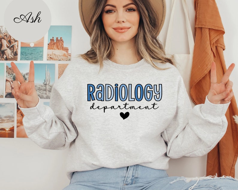 May include: A gray sweatshirt with the text "RADIOLOGY department" in blue and black lettering with a small black heart below the text.