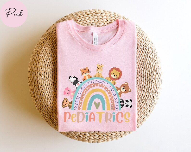 May include: Pink t-shirt with a rainbow and animals around it. The text "PEDIATRICS" is below the rainbow.
