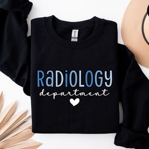 May include: Black sweatshirt with the text "RADIOLOGY department" in blue and white lettering with a white heart.