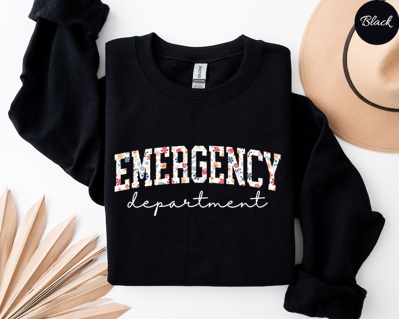 May include: Black sweatshirt with a floral print of the words "EMERGENCY department" in white.