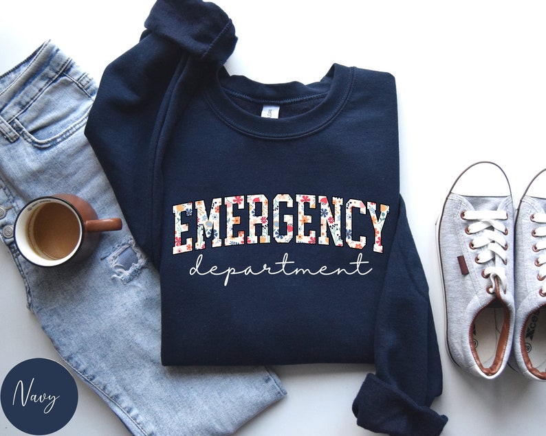 May include: Navy blue sweatshirt with a floral print design that says "EMERGENCY department" in white lettering.