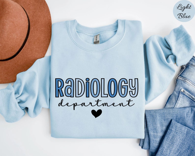 May include: Light blue sweatshirt with the text "Radiology department" in blue and black lettering with a black heart.