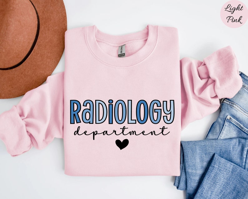May include: Light pink sweatshirt with the text "RADIOLOGY department" in blue gradient lettering and a black heart.