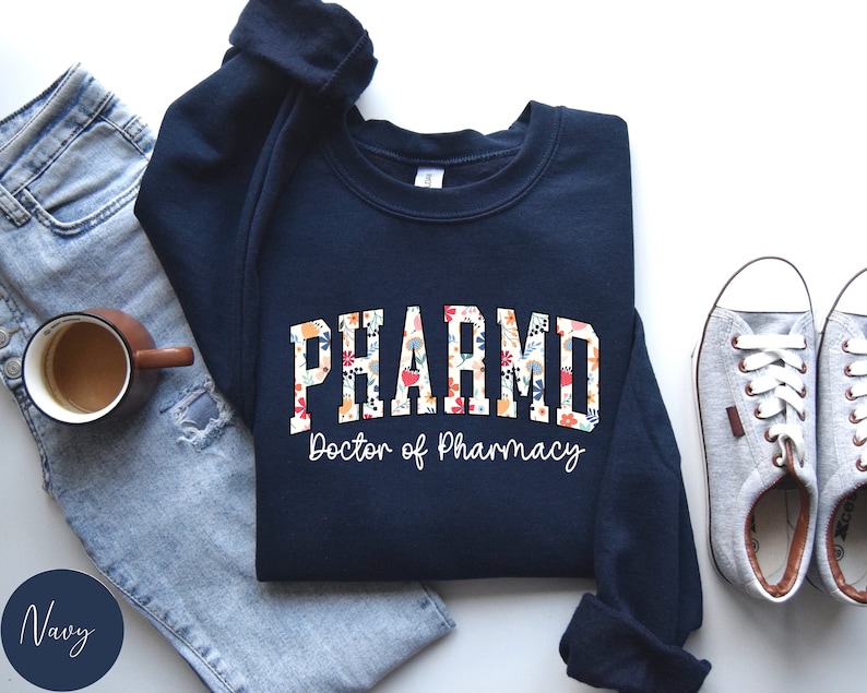 May include: Navy blue sweatshirt with a floral design and the text "PHARM.D. Doctor of Pharmacy".