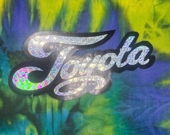 Cinta adhesiva holográfica prismática vintage de Toyota, color plata y negro.