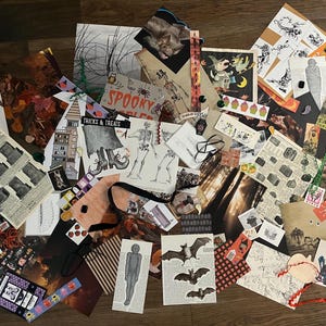 May include: A collection of assorted paper ephemera featuring Halloween-themed illustrations, including skeletons, bats, tombstones, and vintage-style graphics. The collage contains various printed cards, stickers, and cutouts with text like Spooky.