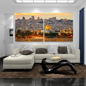 May include: A panoramic view of a city skyline at sunset with a golden dome building in the center. The city is lit up with lights and the sky is a mix of orange, pink, and purple.