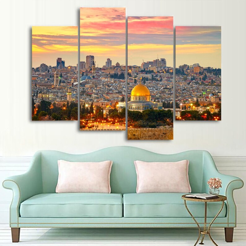 May include: A panoramic view of Jerusalem at sunset, featuring the Dome of the Rock with its golden dome, surrounded by the city's buildings and a lush green landscape.