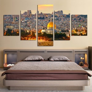 May include: A five-piece canvas print set depicting a panoramic view of Jerusalem at sunset. The Dome of the Rock, a golden-domed mosque, is prominently featured in the center of the image. The cityscape is filled with buildings and trees, creating a vibrant and detailed scene.