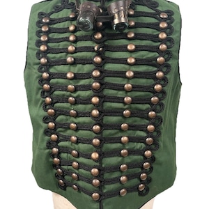 May include: Green vest with black rope detailing and bronze-colored buttons. The vest has a high collar and is adorned with a pair of steampunk goggles. The vest is displayed on a mannequin.