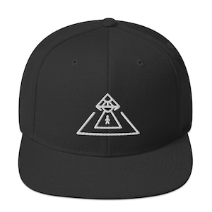 May include: Black and white embroidered baseball cap with a white triangle design featuring a UFO and a person standing in the center.