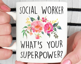May include: White coffee mug with a floral design and the text "Social Worker What's Your Superpower?"