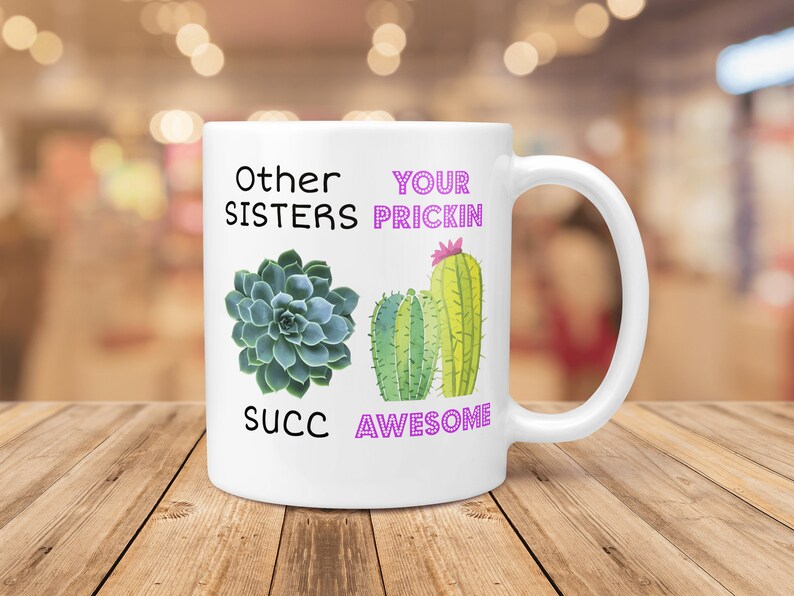 May include: White ceramic mug with a cactus and succulent design. The mug reads "Other Sisters Succ" and "Your Prickin Awesome".