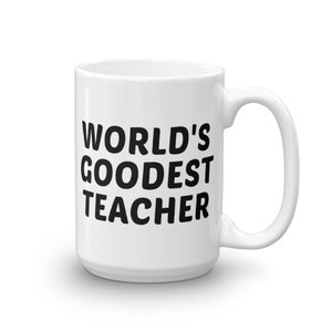 May include: White ceramic mug with the text "WORLD'S GOODEST TEACHER" in bold black letters. The mug has a curved handle and a glossy finish. The mug is a standard size for coffee or tea.