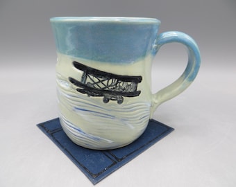 Embossed Pottery Mug: Airplane Design, Hand-Built Ceramic