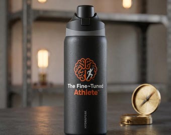 May include: A matte black water bottle with a black lid and a grey accent ring. The front features an orange brain icon with a white runner silhouette, the text "The Fine-Tuned Athlete", and the brand name "HYDRAPEAK" printed in white.
