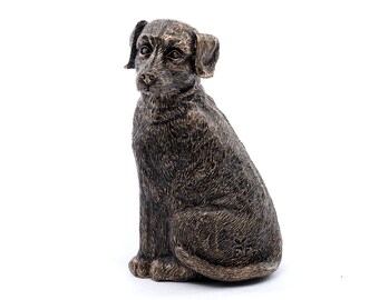 May include: A bronze sculpture of a dog sitting with its head tilted to the side. The dog is brown and has a textured surface.