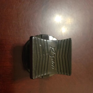 May include: Black plastic bottle stopper with the word "Rema" embossed on the top.