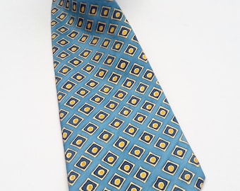May include: A blue silk tie with a geometric pattern of yellow and navy blue squares.