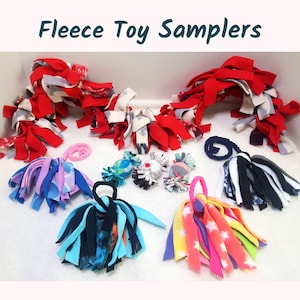May include: A collection of colorful fleece toy samplers for dogs. The toys are made of various colors of fleece fabric, including red, white, blue, pink, and black. The toys are tied together in a variety of ways, creating a variety of shapes and sizes.