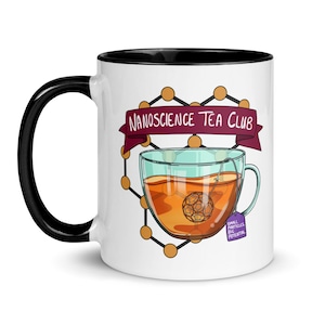 May include: White ceramic mug with a black interior and handle. The mug features a graphic of a teacup with tea and a tea infuser. The text "NANOSCIENCE TEA CLUB" is on a banner above the teacup. A tag reads "SMALL PARTICLES BIG POTENTIAL".