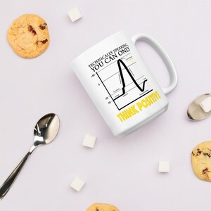 May include: White ceramic mug with a black and yellow graphic that says "Technically speaking, you can only think positive." The graphic is a line graph with a sharp upward spike at the end.