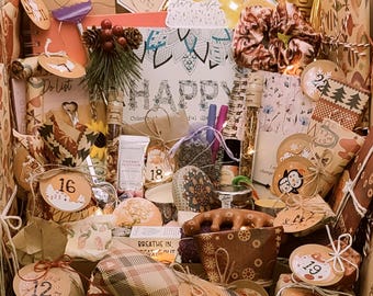May include: An open gift box filled with various items, including wrapped packages, a coloring book with the word "HAPPY", and small decorative items. The box contains items with numbers 10, 12, 16, 18, and 19.