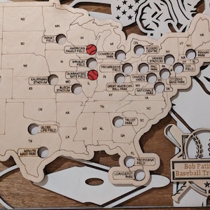 May include: A wooden map of the United States with baseball stadiums marked with red baseballs. The map is titled "Bob Patitucci's Baseball Travel Map".