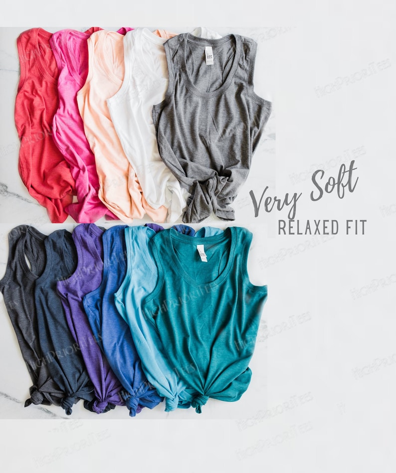 May include: A stack of ten sleeveless shirts in various colors, including red, pink, peach, white, gray, black, purple, blue, teal, and green. The shirts are arranged in a row, with the top row slightly overlapping the bottom row. The shirts are all made of a soft, comfortable fabric and have a relaxed fit. The text "Very Soft Relaxed Fit" is printed on a white background in the upper right corner of the image.