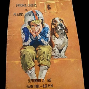 May include: A vintage program for a football game between the Friona Chiefs and the Plains Cowboys. The program features a cartoon illustration of a boy in a football uniform sitting with a basset hound. The text on the program reads "Friona Chiefs vs. Plains Cowboys, September 21, 1962, Game Time - 8:00 P.M."
