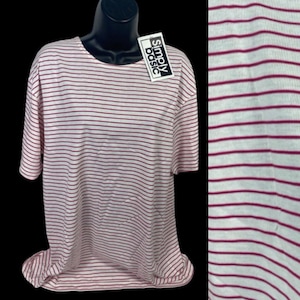 May include: A white and burgundy striped t-shirt with a "Simply Basic" tag attached. The shirt has a crew neck and short sleeves.