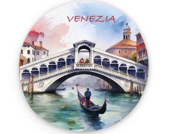 May include: A watercolor painting of a bridge in Venice, Italy. The bridge is white with arches and is over a canal. A gondola is in the water under the bridge. The text "VENEZIA" is written in red at the top of the image.